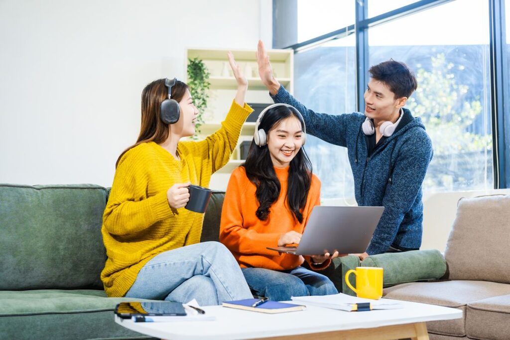 Working students studying together with a laptop in a condominium living area