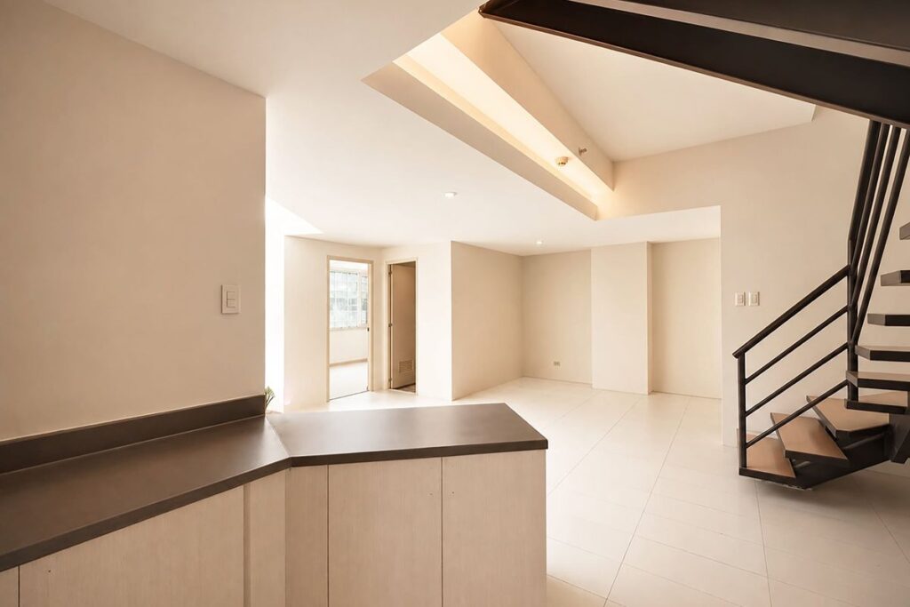 Bright residential loft unit at The Exchange Regency with an open living area and staircase