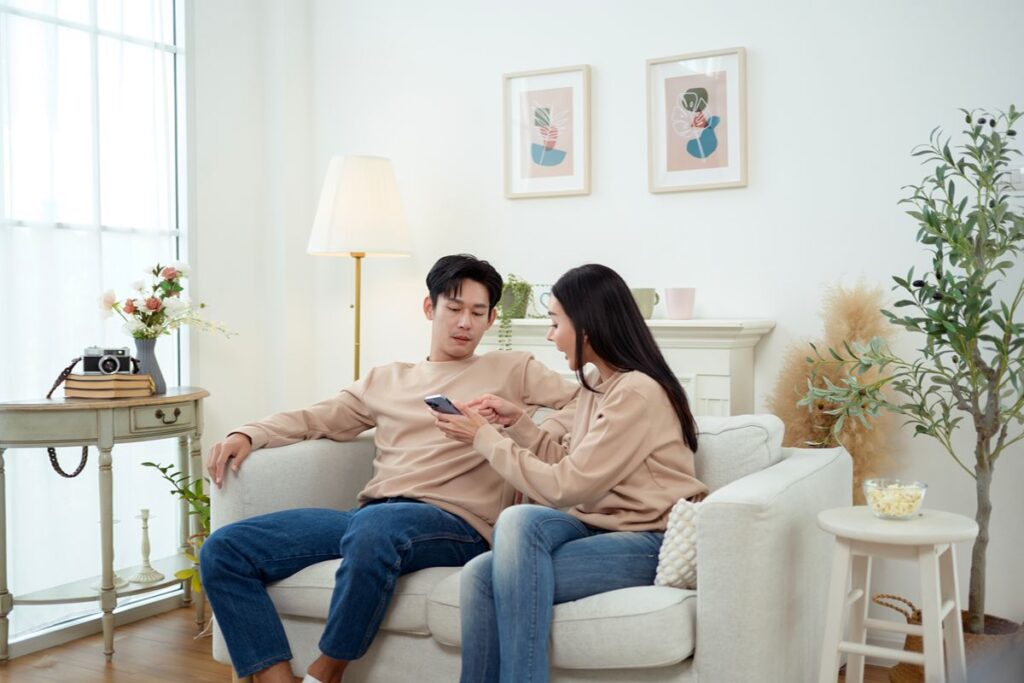 Couple relaxing together on a sofa in a one-bedroom condominium