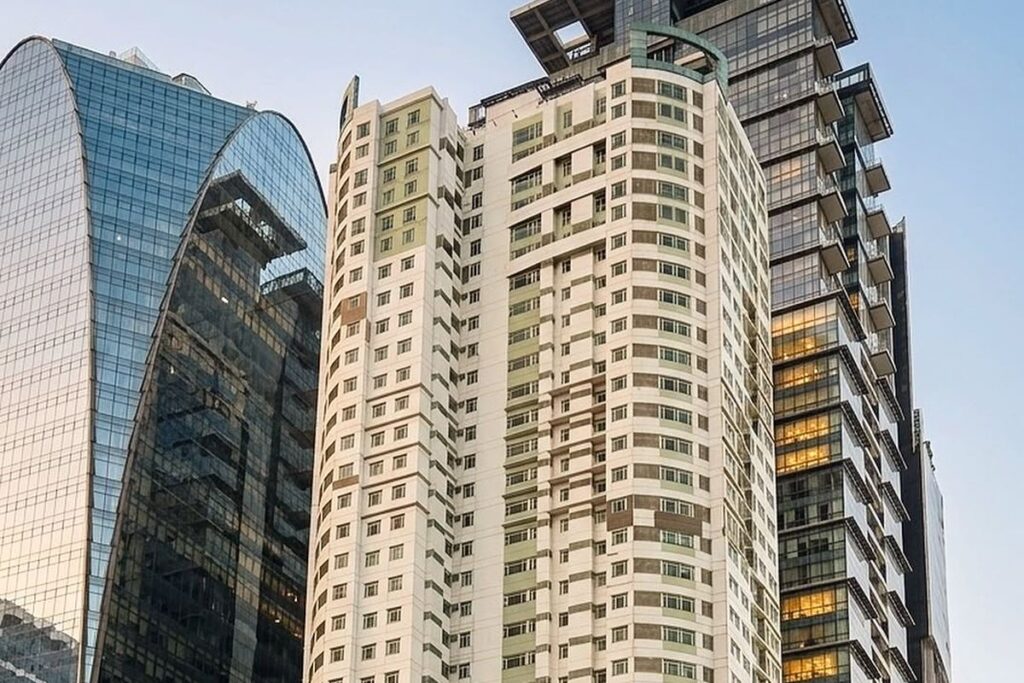 High-rise condominium building surrounded by modern office towers